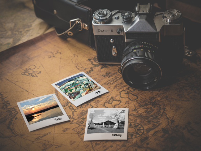 Camera and Map with Arts, Parks, and History Poloroids.